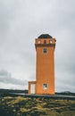 Orange Lighthouse Svortuloft Skalasnagi tower in Snaefellsnes Peninsula, west Iceland on an overcast day.