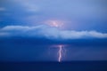 Orange lightning over the sea strikes through the cloud Royalty Free Stock Photo