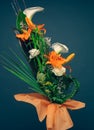 Orange lilies, white calla flowers and palm tree leaves bouquet vertical color image studio shot. Mothers day concept background,
