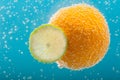 Orange and lime slice in bubbles water