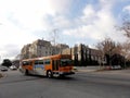 Orange Local Metro Bus 14 rolls down the street