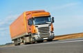 Orange lorry trailer over blue sky Royalty Free Stock Photo