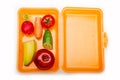 Orange lunch box with fuit and vegetables Royalty Free Stock Photo
