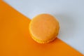 Orange macaroon is on the orange-white background