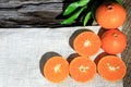 Orange mandarin or tangerine fruits, with green leaves on wooden board background Royalty Free Stock Photo