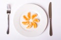 Orange mandarin on white plate