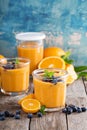 Orange and mango smoothie with granola and berries Royalty Free Stock Photo