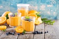 Orange and mango smoothie with granola and berries Royalty Free Stock Photo