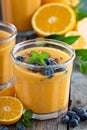 Orange and mango smoothie with granola and berries Royalty Free Stock Photo