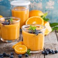 Orange and mango smoothie with granola and berries Royalty Free Stock Photo