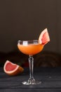 Orange margarita alcohol cocktail with grapefruit on black table Royalty Free Stock Photo