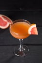 Orange margarita alcohol cocktail with grapefruit on black table Royalty Free Stock Photo