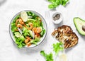 Orange marinated prawns, avocado, garden herbs salad - delicious healthy snack, appetizers, tapas on a light background, top view.