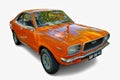 Orange Mazda 808 reflecting trees parked on white background Royalty Free Stock Photo