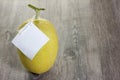 Orange melon on wood table with white lable