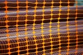 Orange mesh stretched around sewer pipes