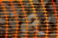 Orange mesh stretched for safety of road repair work
