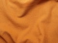 Orange microfleece crumpled fabric Royalty Free Stock Photo
