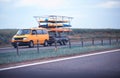 An orange minibus transports a trailer with kayaks for swimming on the river. Travel and recreation. Copy space for text Royalty Free Stock Photo