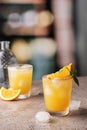 Orange and mint cocktails, soft drinks on bar with text space