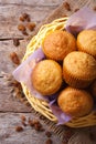 Orange muffins in a basket and raisins top view vertical