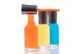 Orange nail polish brush on bottle