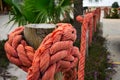 Orange nautical rope on wood poles