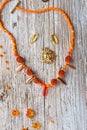 orange necklace with glass beads presented around old style wooden background. flat lay.fashion and handmade concept Royalty Free Stock Photo