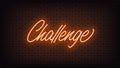 Orange neon Challenge, lettering. Neon text of Challenge on black brick background