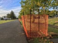 Orange netting along park pathway Royalty Free Stock Photo