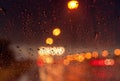 Orange night light bokeh from street light on traffic jam day. Rainy day. Transparent glass window with rain drop. Romantic Royalty Free Stock Photo