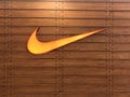 Orange Nike logo on the wood suffice