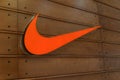 Orange Nike logo on wooden background c