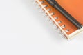 Orange note book and black pen Royalty Free Stock Photo
