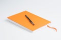 Orange note book and pen Royalty Free Stock Photo