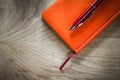 Orange notebook ballpoint pen top view Royalty Free Stock Photo