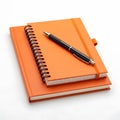 Orange notebook and pen isolated on white background Royalty Free Stock Photo