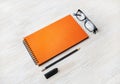 Orange notepad, glasses, pencil, eraser