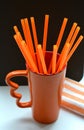 Orange objects cup and tubes