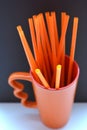 Orange objects cup and tubes