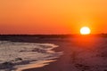 Orange Ocean beach sunset. Tropical Gulf Coast ocean beach sunset scene.
