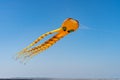 orange octopus kite flying on the blue sky in the kite festival