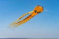 orange octopus kite flying on the blue sky in the kite festival