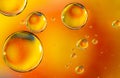 Orange oil drops in water. Bubbles of different sizes on orange background Royalty Free Stock Photo