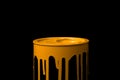 Orange oil paint flowing down on wall of metal bucket. Isolated over black background Royalty Free Stock Photo