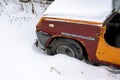 A orange old car under snow. Close up. Royalty Free Stock Photo