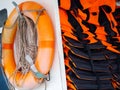 Orange old Lifebuoy with life jacket close up. Royalty Free Stock Photo