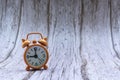 Orange old retro style alarm clock on wooden background Royalty Free Stock Photo