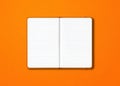Orange open lined notebook isolated on colorful background Royalty Free Stock Photo