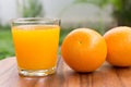 Orange and orange juice on wooden background